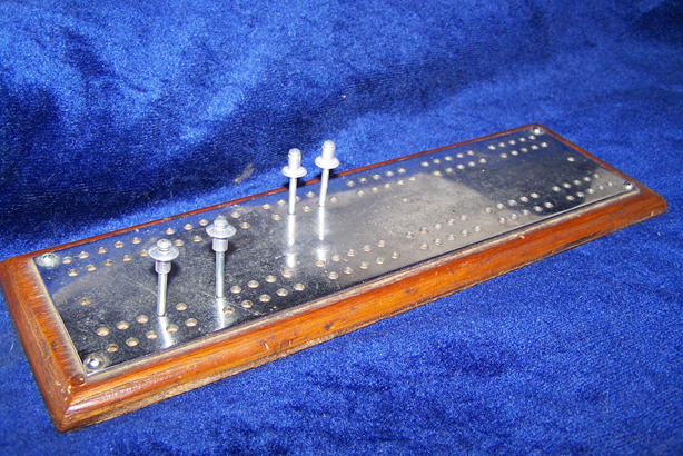 A small, two player cribbage board